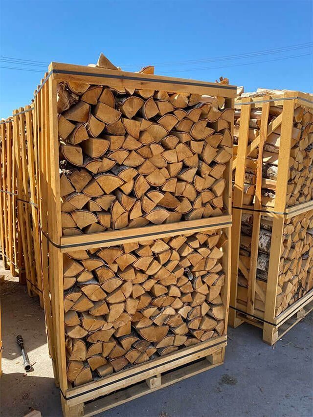 Wooden crates of kiln-dried firewood stacked in the yard